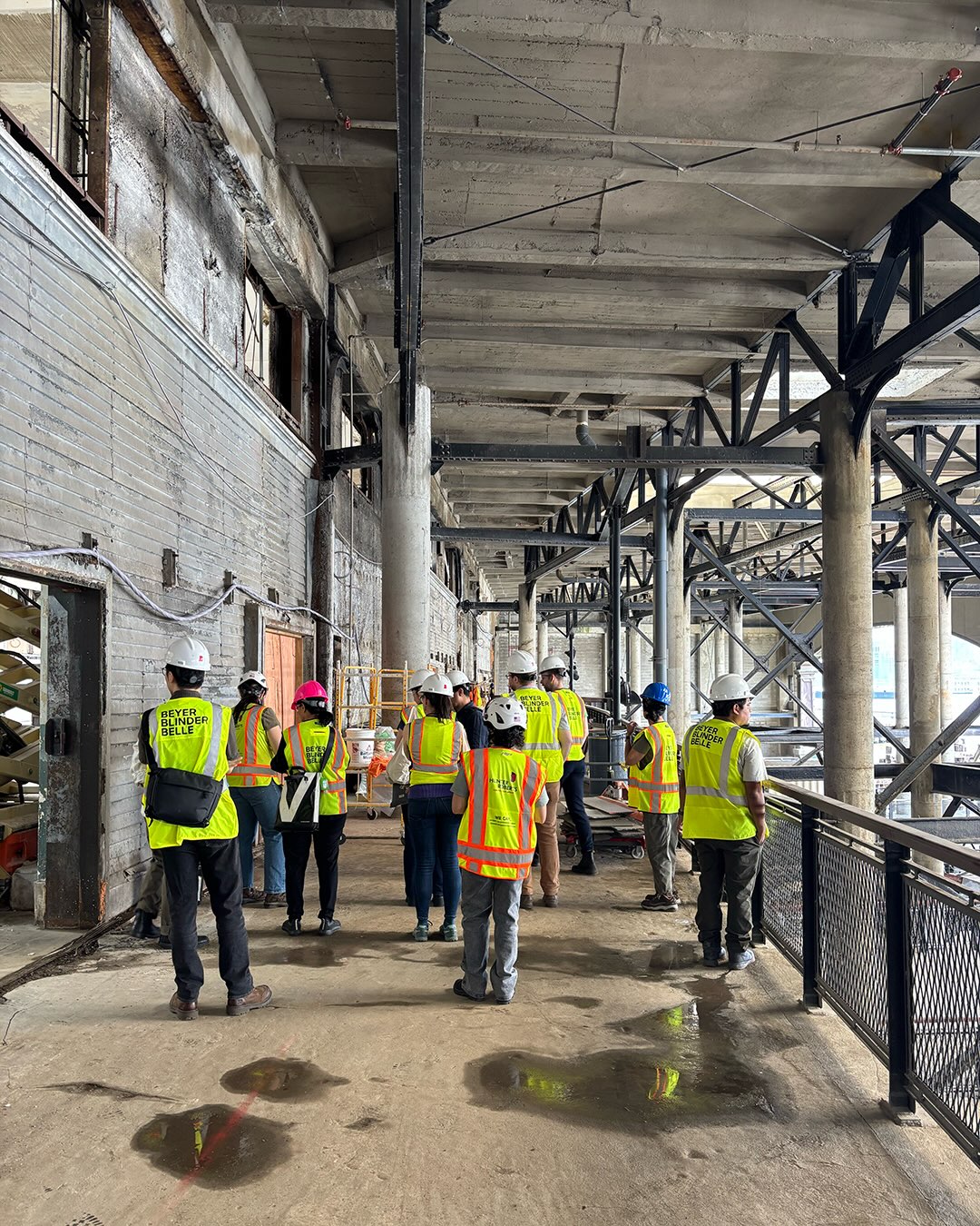 Beyer Blinder Belle team in branded hi-vis vests on a site walk through an active construction project